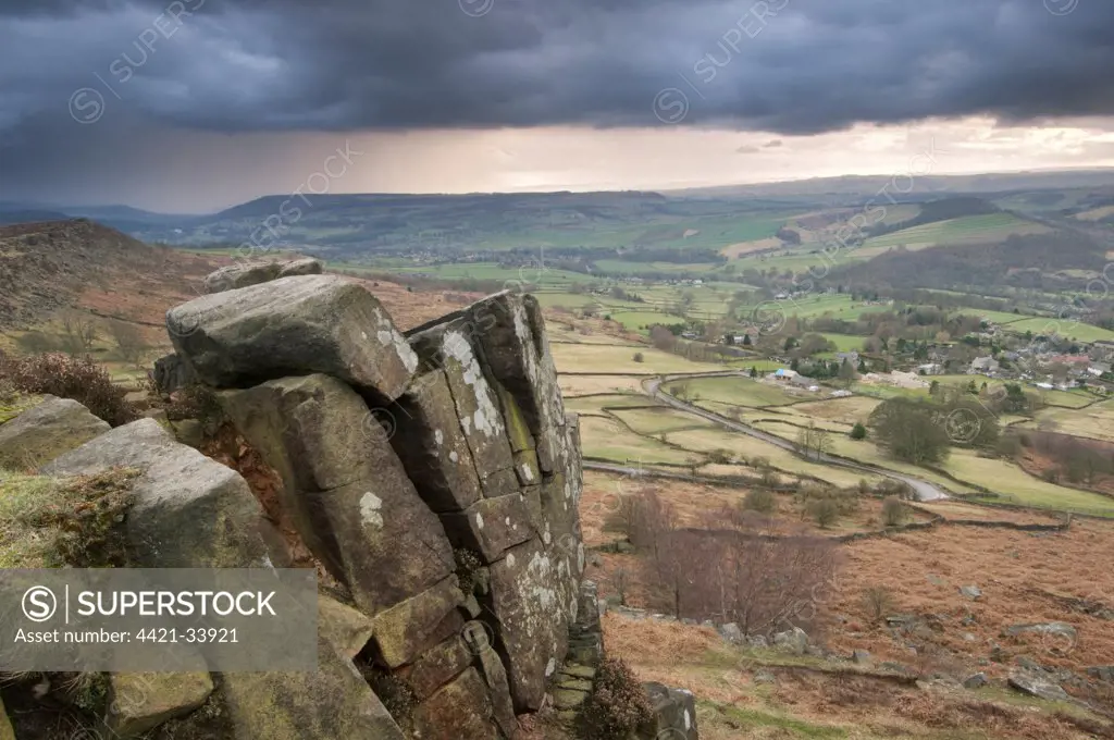 View of upland habitat and gritstone edge with approaching storm, Curbar Edge, Peak District, Derbyshire, England, march