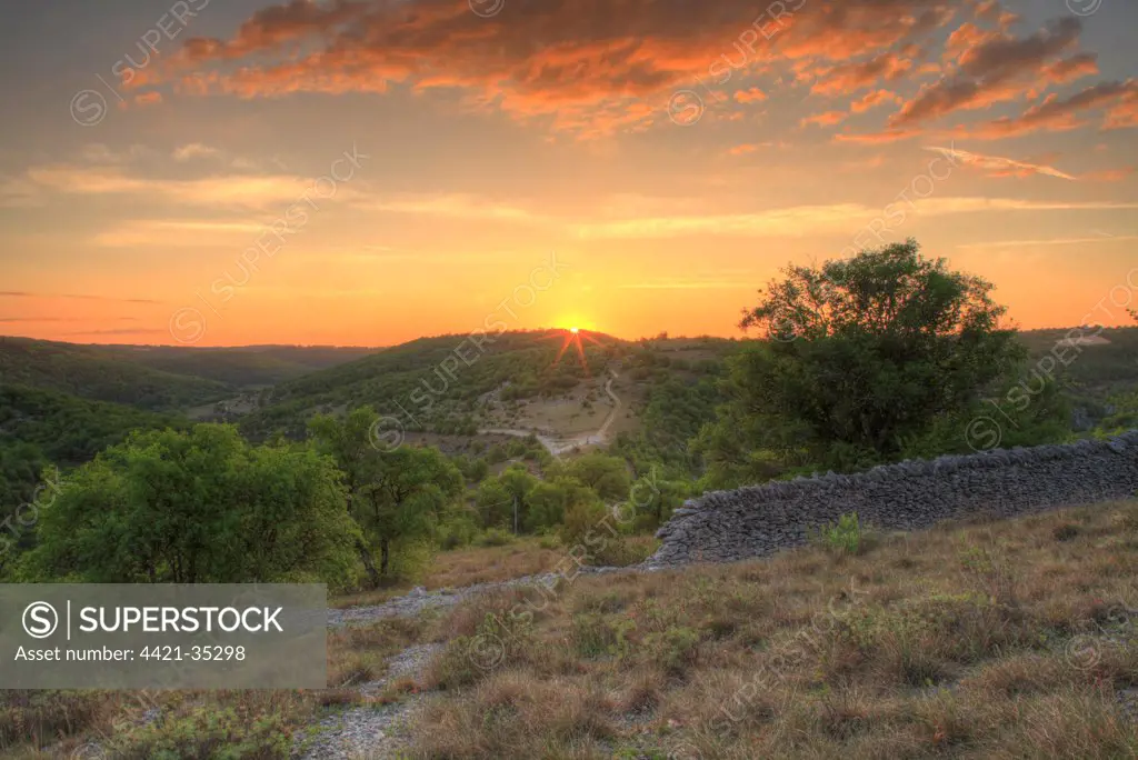 View of rural landscape at sunset, near Rocamadour, Causse de Gramat, Massif Central, Lot, France, may