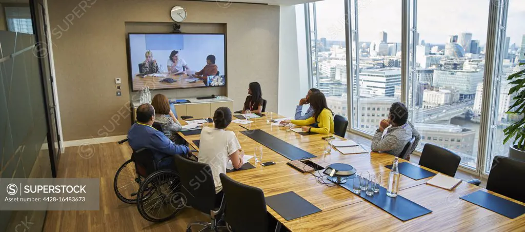 Business people video conferencing in conference room meeting