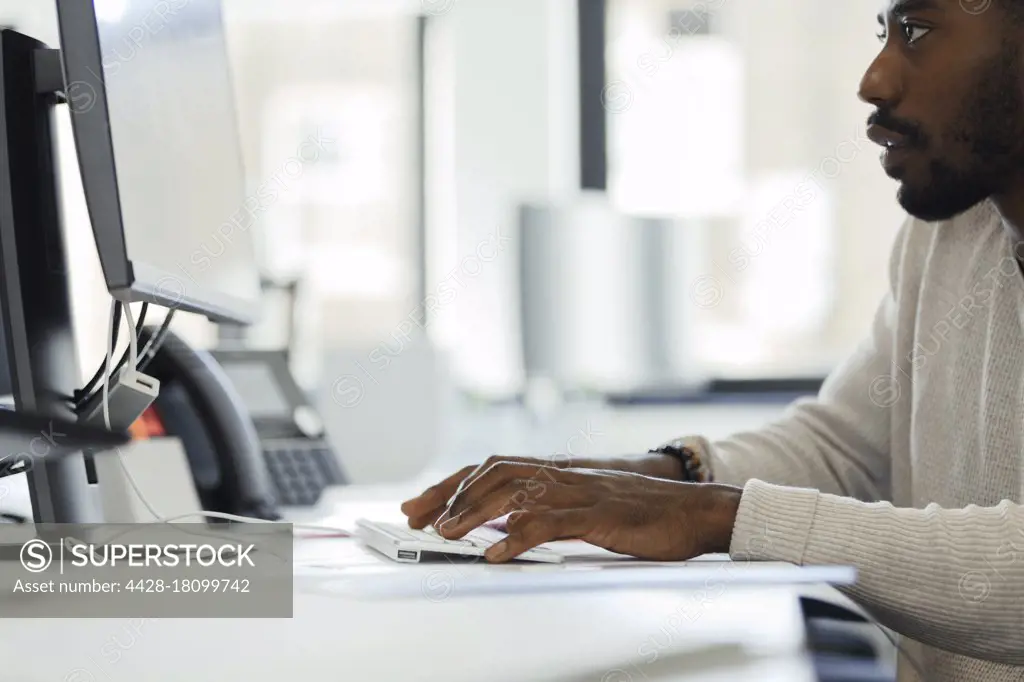 Businessman working at computer at office desk