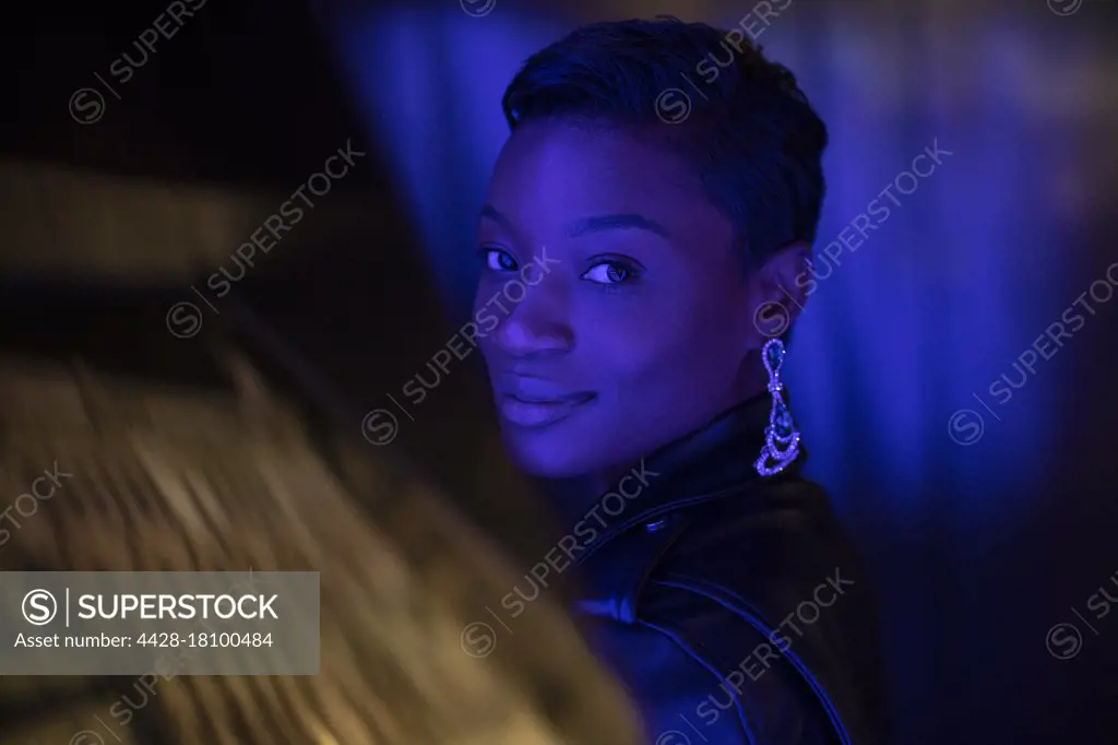 Portrait beautiful young woman in dark blue light