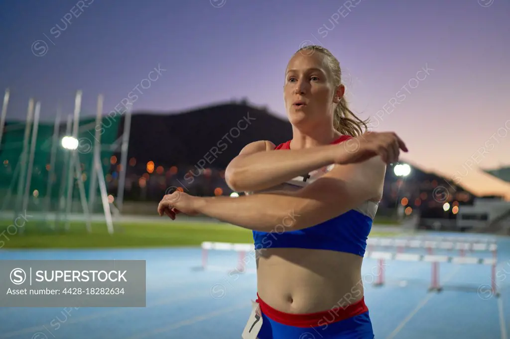 Female track and field athlete preparing for competition on track