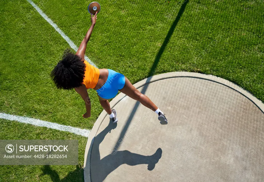 Female track and field athlete throwing discus