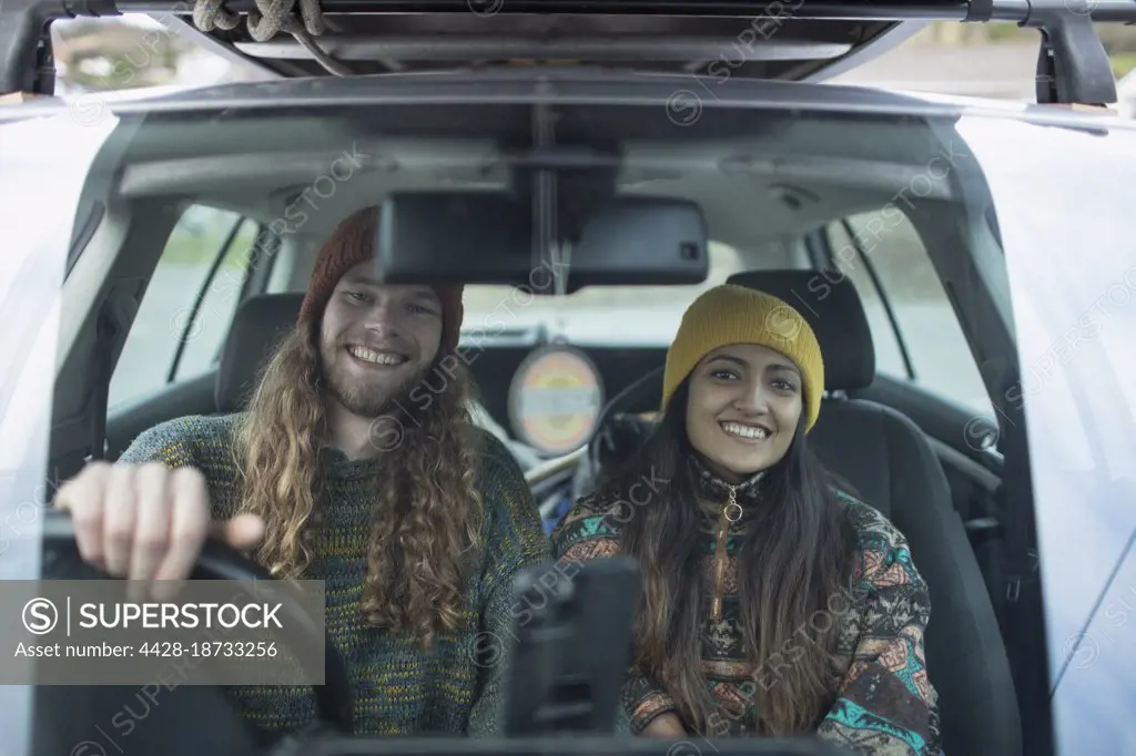 Portrait happy couple on road trip in car