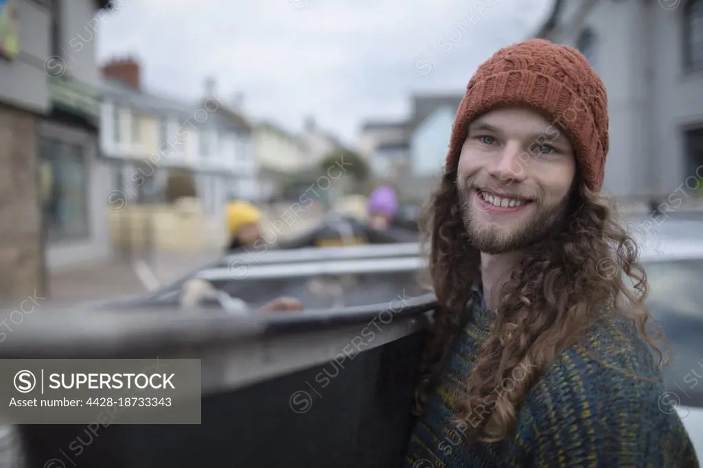 Portrait happy young man with canoe