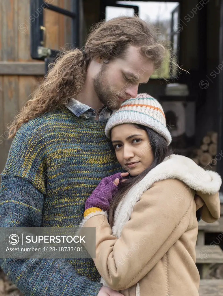 Portrait serene affectionate young couple hugging