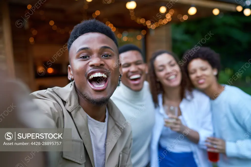 Selfie POV portrait happy gay couples laughing in backyard