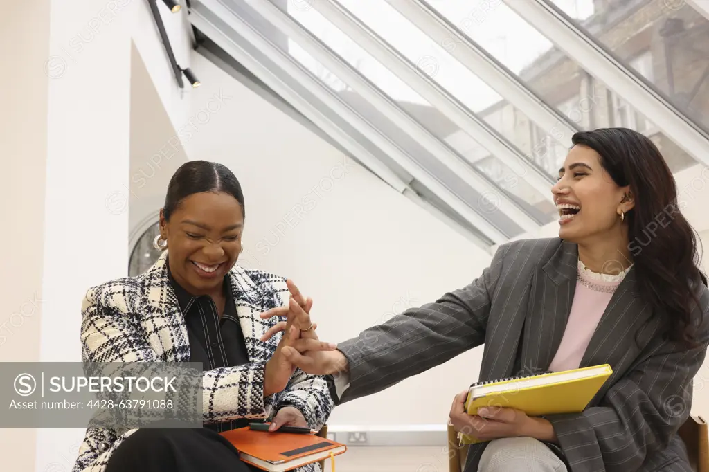 Businesswomen laughing in office