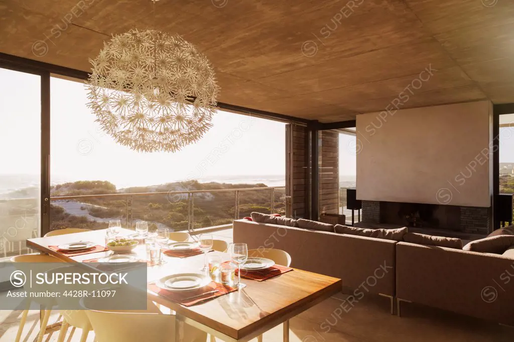 Modern dining room and living room overlooking ocean