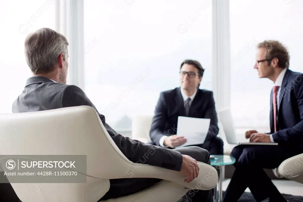 Businessmen talking in office lobby