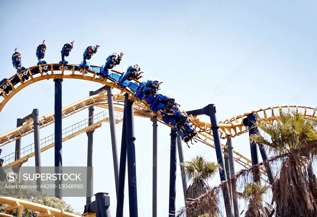 People flipping upside-down on amusement park ride