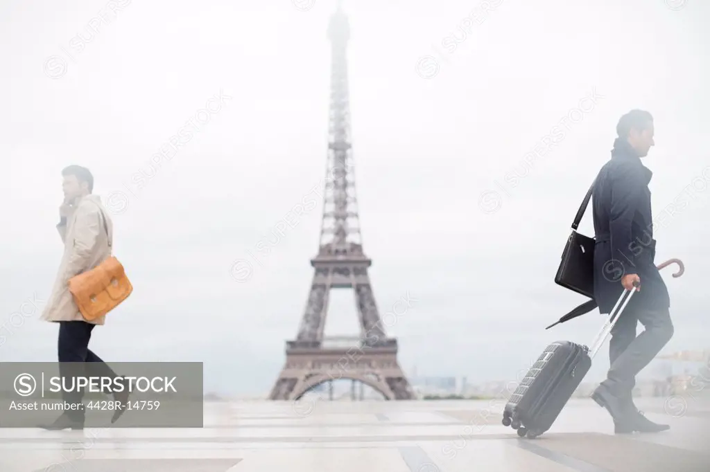 Business people walking past Eiffel Tower, Paris, France, Paris, France