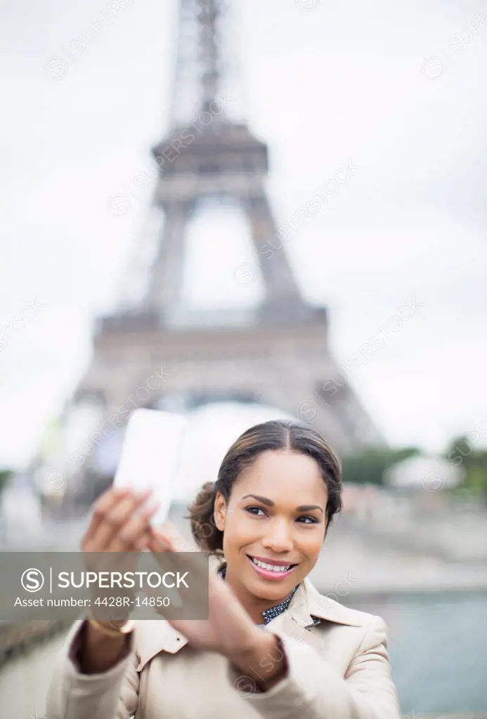 Woman taking self-portrait in front of Eiffel Tower, Paris, France, Paris, France