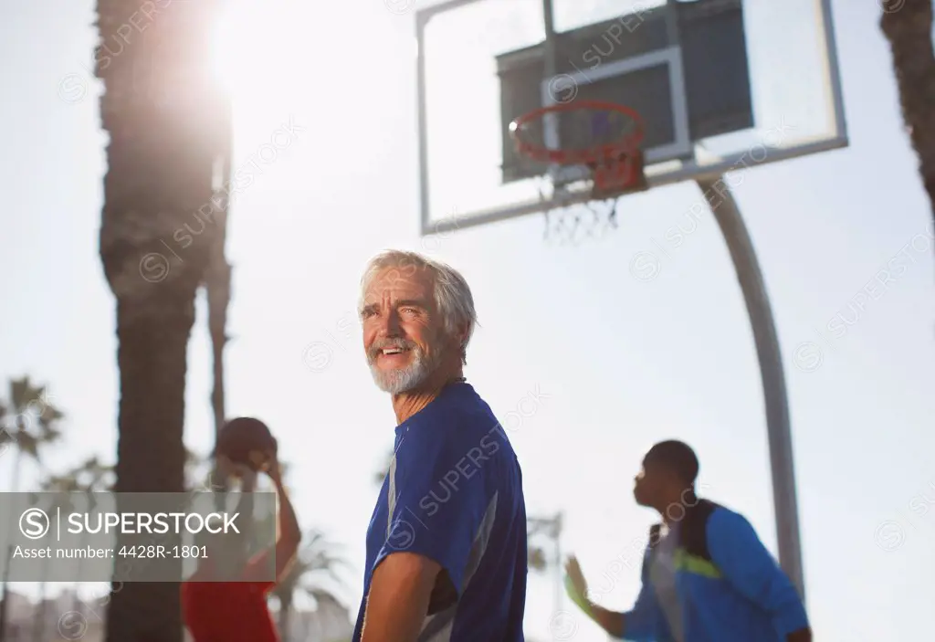 Los Angeles, USA, Older men playing basketball on court