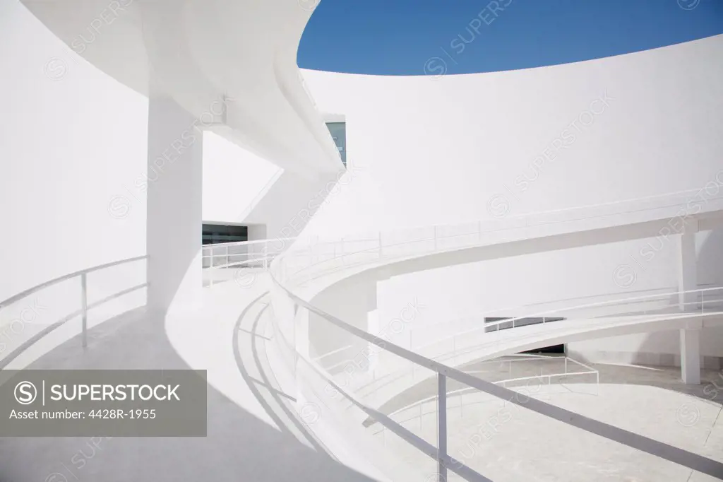 Spain, Businessman ascending curving elevated walkway