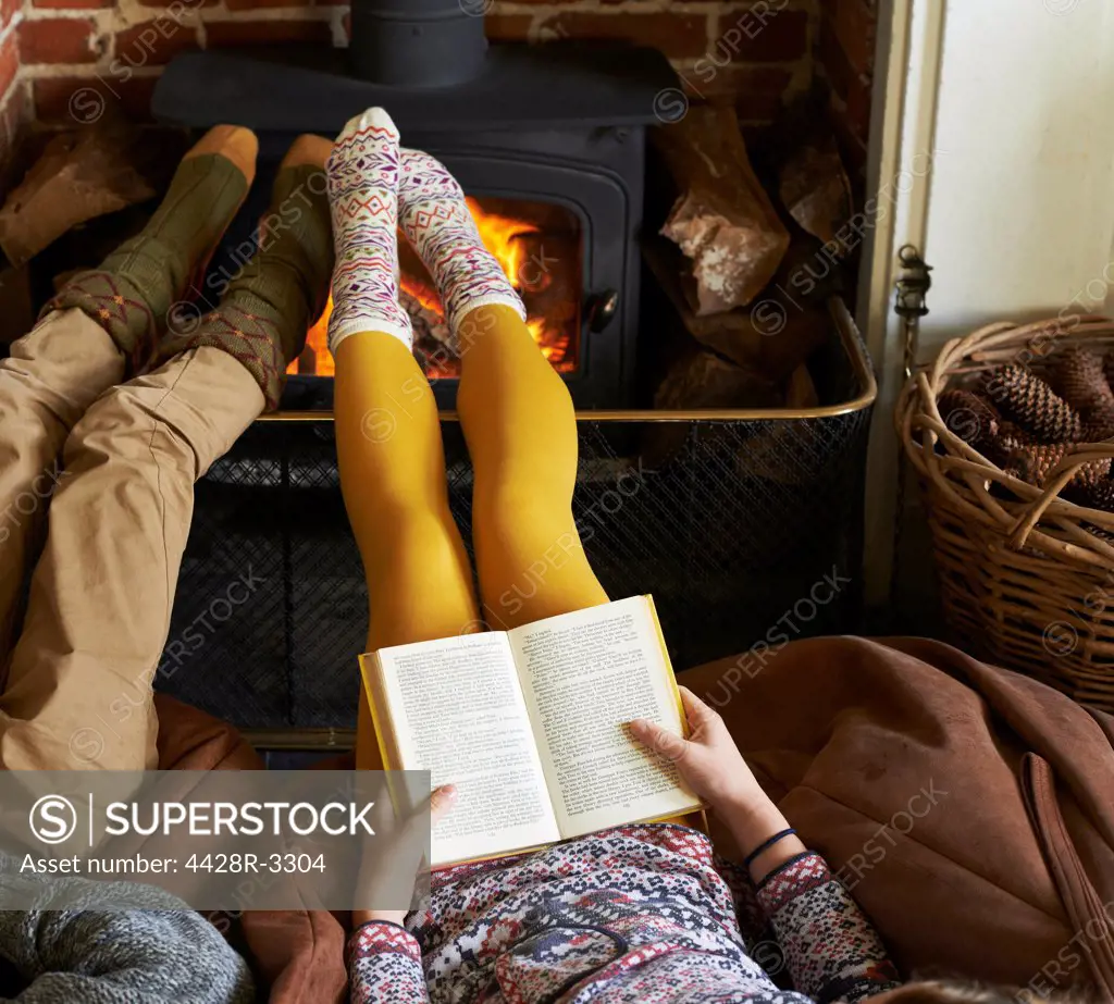 Children relaxing by fire,belmonthouse, UK