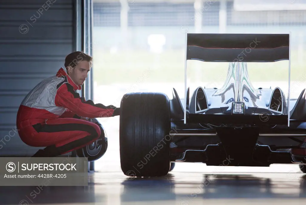 Mechanic working on race car in garage,Corby, UK