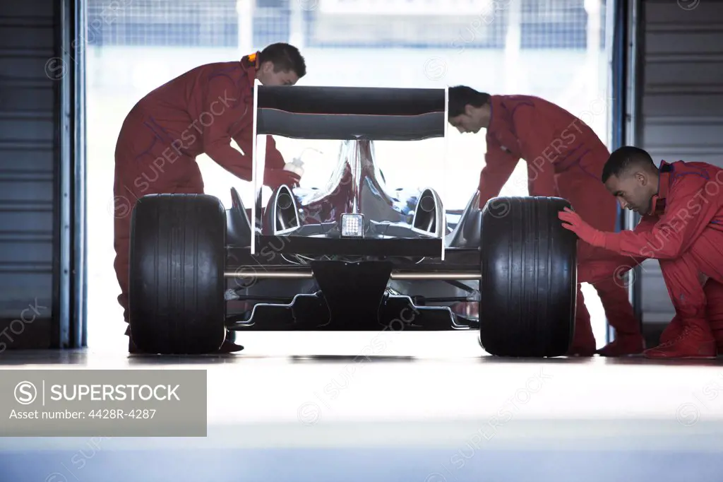 Racing team working in garage,Corby, UK