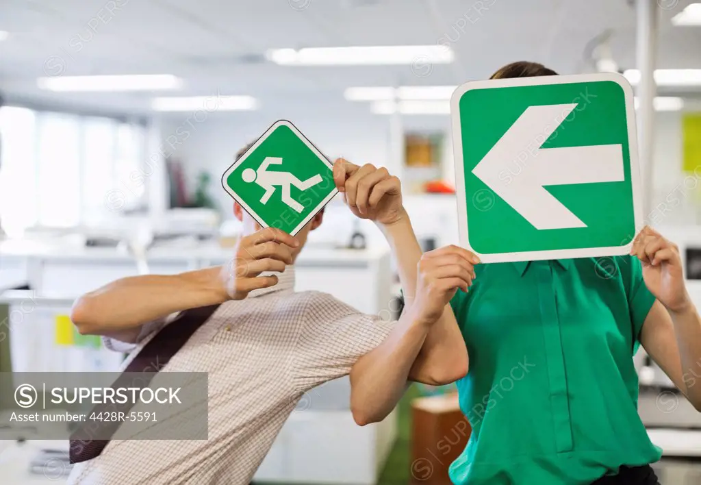 Business people holding signs in office