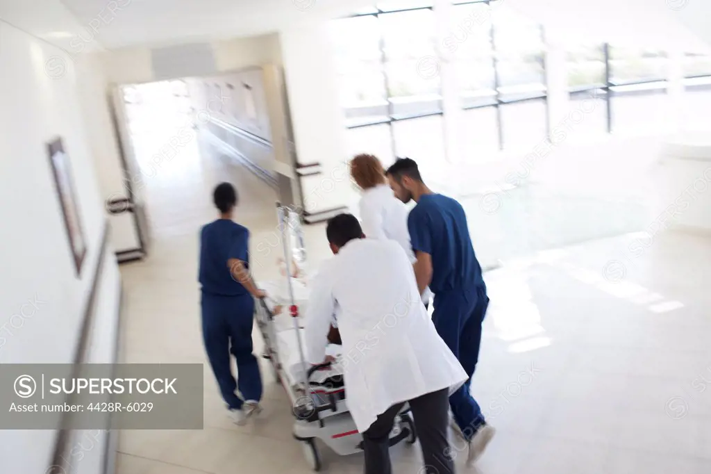 Hospital staff rushing patient to operating room