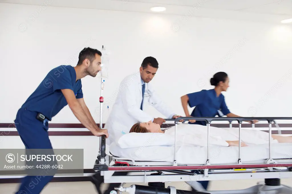 Hospital staff rushing patient to operating room