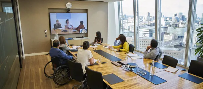 Business people video conferencing in conference room meeting