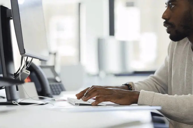 Businessman working at computer at office desk