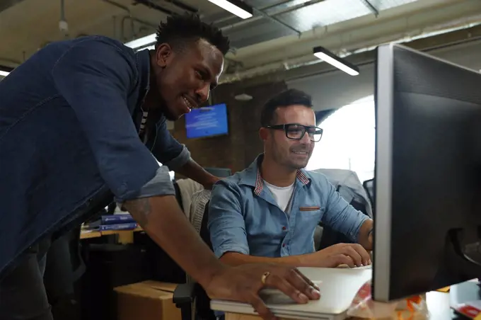 Businessmen working at computer in office