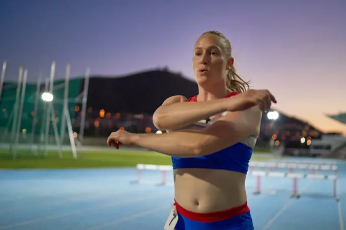 Female track and field athlete preparing for competition on track