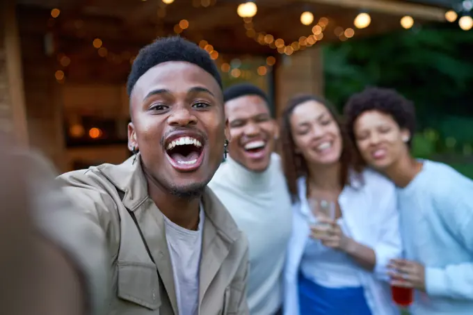 Selfie POV portrait happy gay couples laughing in backyard