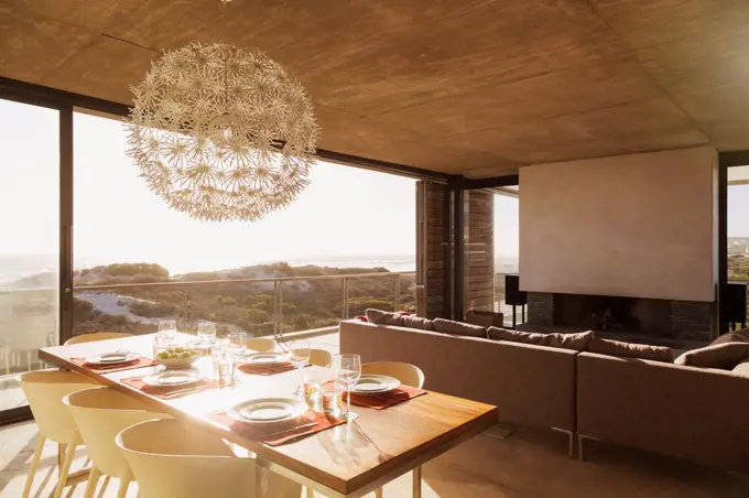 Modern dining room and living room overlooking ocean