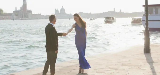 Venice, Well-dressed man and woman at waterfront in Venice