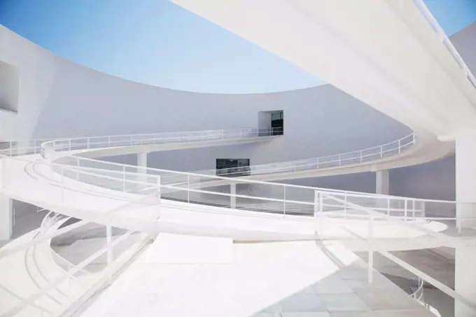 Spain, Curving elevated walkway in modern courtyard