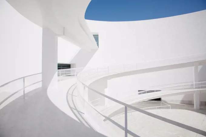 Spain, Businessman ascending curving elevated walkway