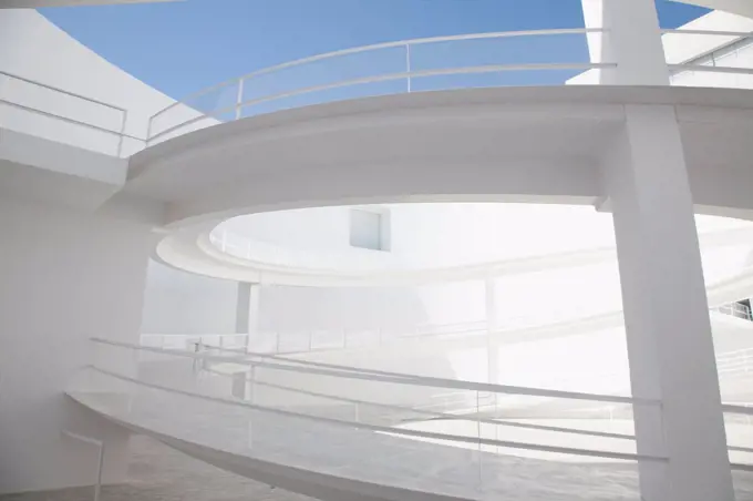 Spain, Curving elevated walkway in modern courtyard