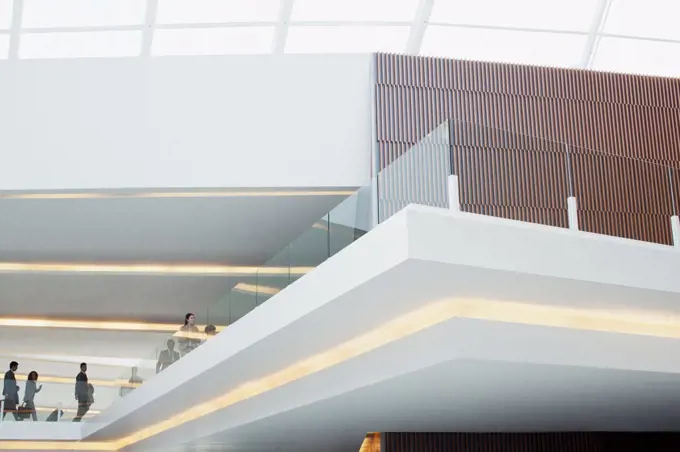 Spain, Business people with suitcases on elevated walkway