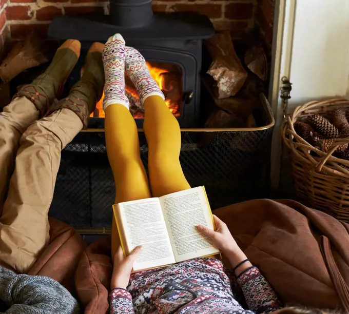 Children relaxing by fire,belmonthouse, UK