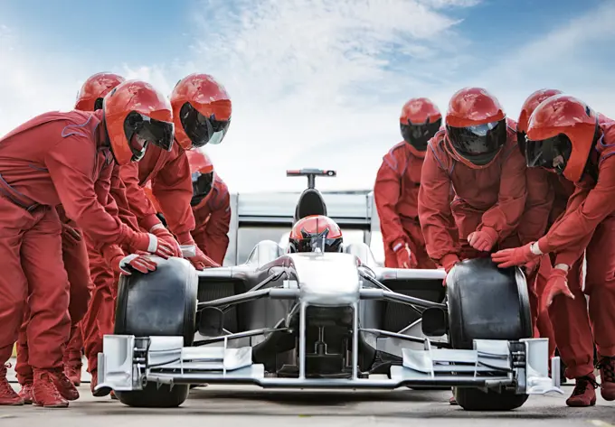 Racing team working at pit stop,Corby, UK