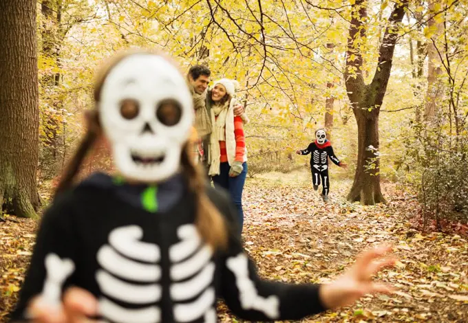 Children in skeleton costumes playing in park,London, UK