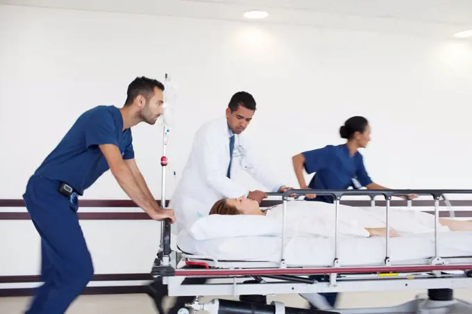 Hospital staff rushing patient to operating room