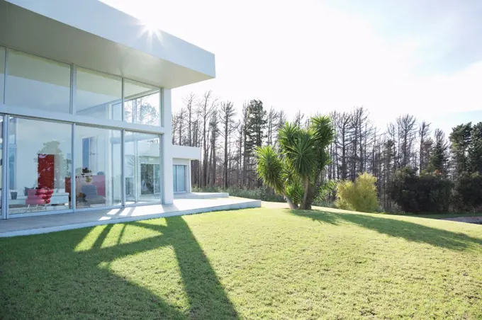 Modern house casting shadows on manicured lawn