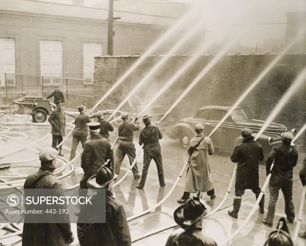 Group of firefighters spraying water