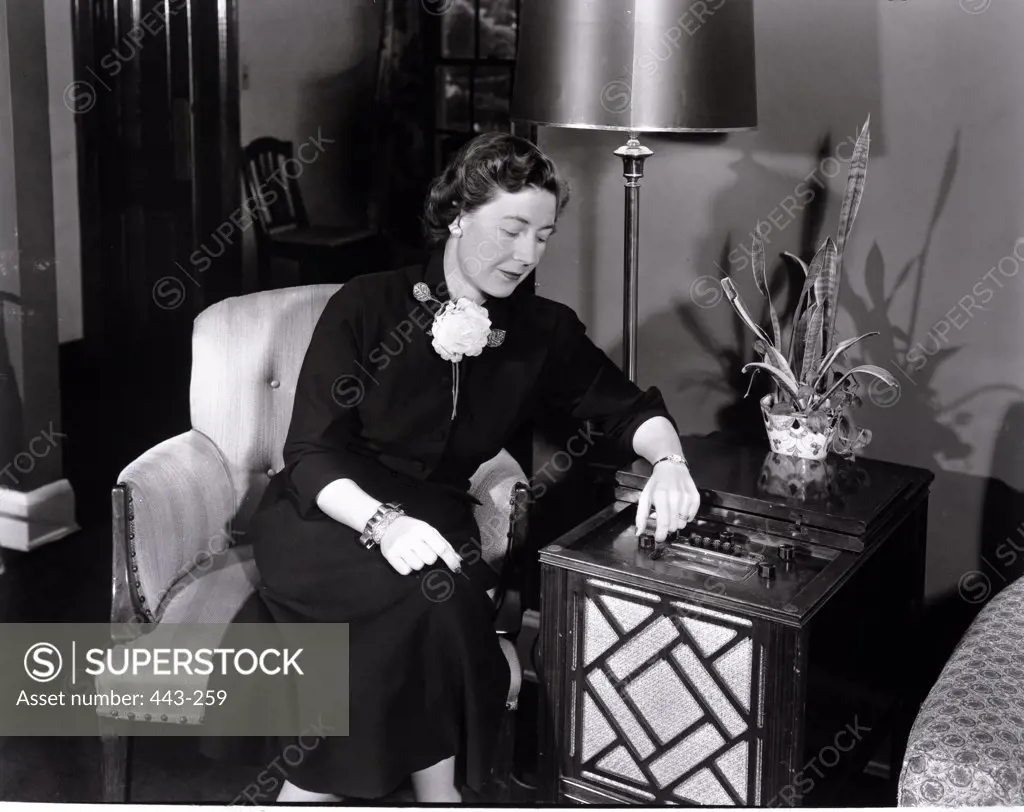 Mature woman sitting in an armchair, 1950