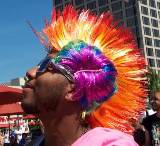 Gay man wearing rainbow colored wig at Worcester Gay Pride, Worcester, Massachusetts, USA