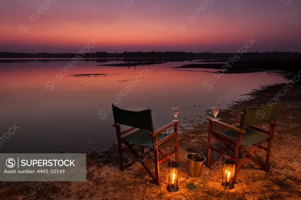 Tourists (guests) having sundowners on the shores of Lake Kushengeza (Shengeza) at Kosi Forest Lodge. Isimangaliso Wetland Park (Greater St Lucia Wetland Park. Manguzi (Kwangwanase). Maputaland. KwaZulu Natal. South Africa.