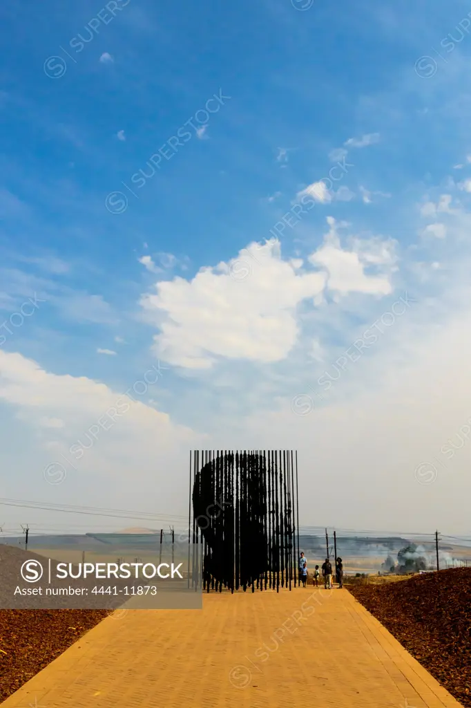 Monument to Mandela comprising of 50 steel columns depicting his face to commemorate 50 years since Mandela was arrested and charged for treason at this location. Designed by Marco Cianfanelli.