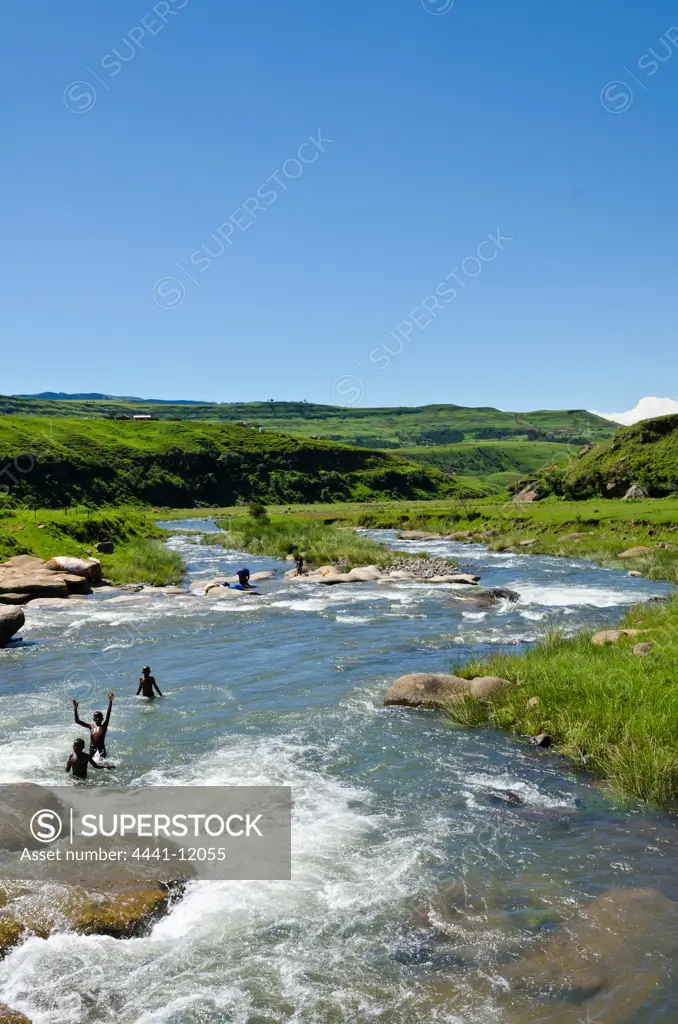 Young boys swimming in Mhlwazini River near the Cathedral Peak region of the Ukhahlamba Drakensberg Park. KwaZulu Natal. South Africa.