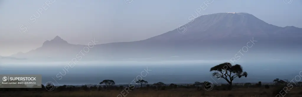 Mount (Mt) Kiliminjaro and Mount (MT)  Mawenzi on the left (in Tanzania) from Amboseli National Park. Kenya.