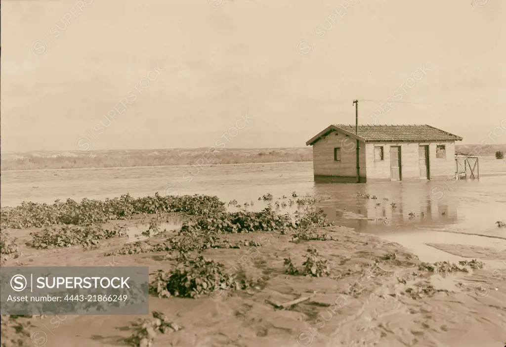 Jordan floods (taken at Allenby Bridge), Bridge guard house in midst of floods. 1935