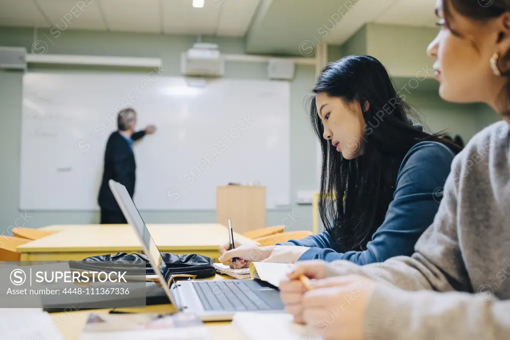 Female students during lesson in classroom